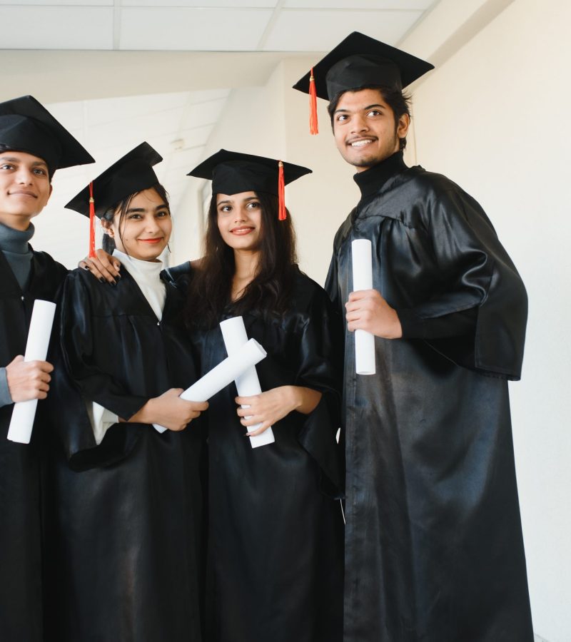 education, graduation and people concept - group of happy indian students